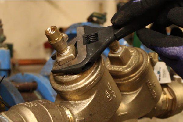 Plumber tightening backflow