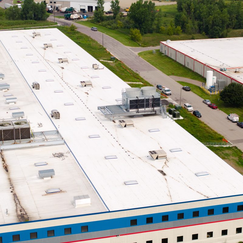 aerial view of industrial building with partial street view